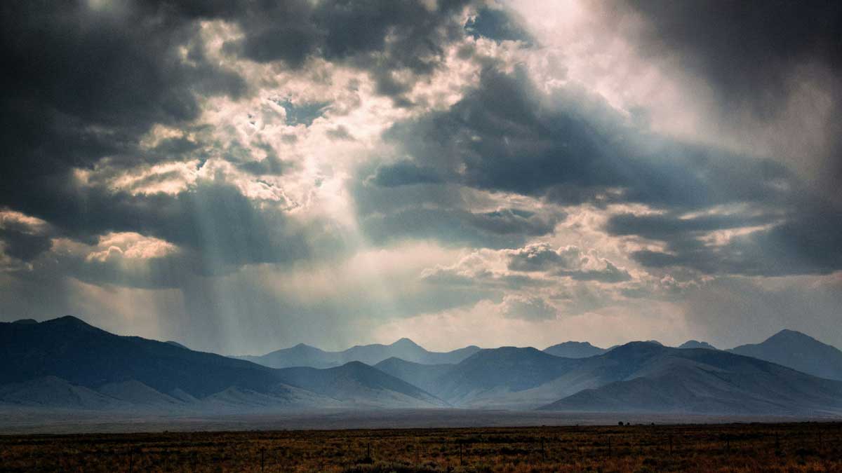 An image of sun rays through clouds for the Fullframe Creative Agency Lausanne Geneve video production blog on preparing for weather conditions advice tips and tricks. Image by Donald Gianatti on Unsplash.