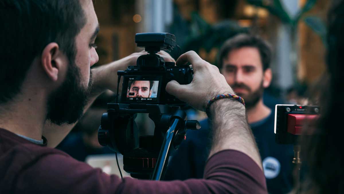 An image of producers filming interview for the fullframe creative agency video production blogpost on corporate video tips trends 2025 lausanne geneva. Image by ohanna buguet on unsplash.