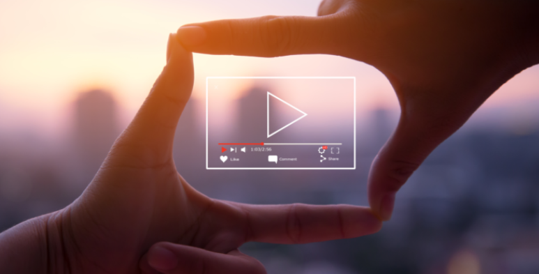 From Viewer to Customer Through Video Ads 76 Thumbnail image showing hands around an illustration of a video for a blog post on video digital advertising, created by Fullframe Creative.