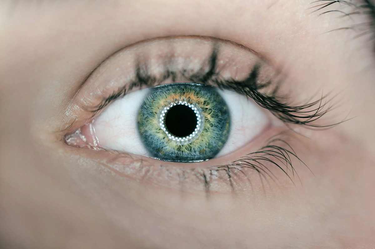 Closeup image of an eye with the reflection of a ring light surrounding the pupil, image by arteum ro on unsplash video production