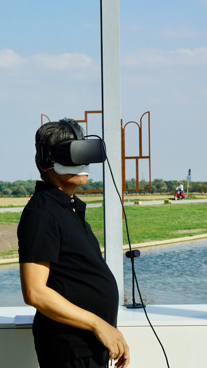 An image of a man wearing a vr helmet outside tourism for the Fullframe blogpost on ar augmented reality, vr virtual reality, mr mixed reality, xr extended reality in video production. Image by beth macdonald on unsplash