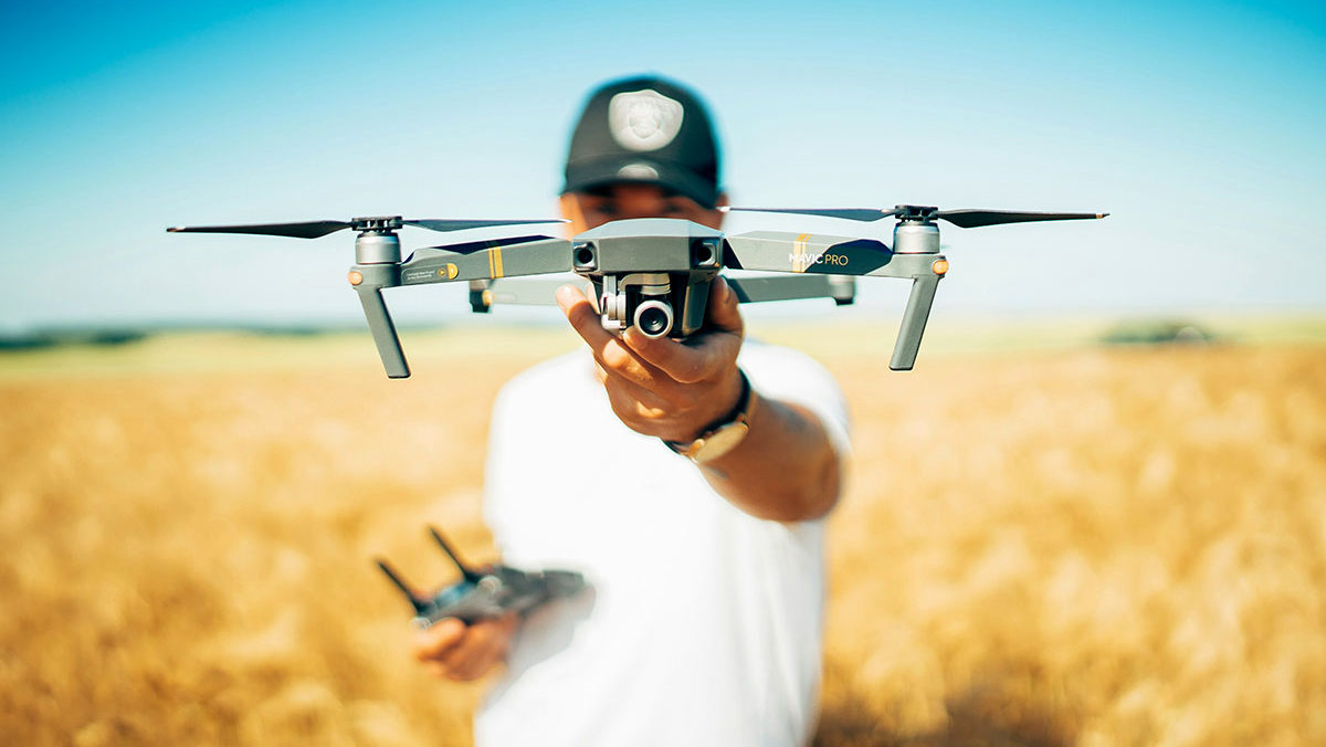 Image of a man holding a video drone for the fullframe blogpost, image by david henrichs on Unsplash.