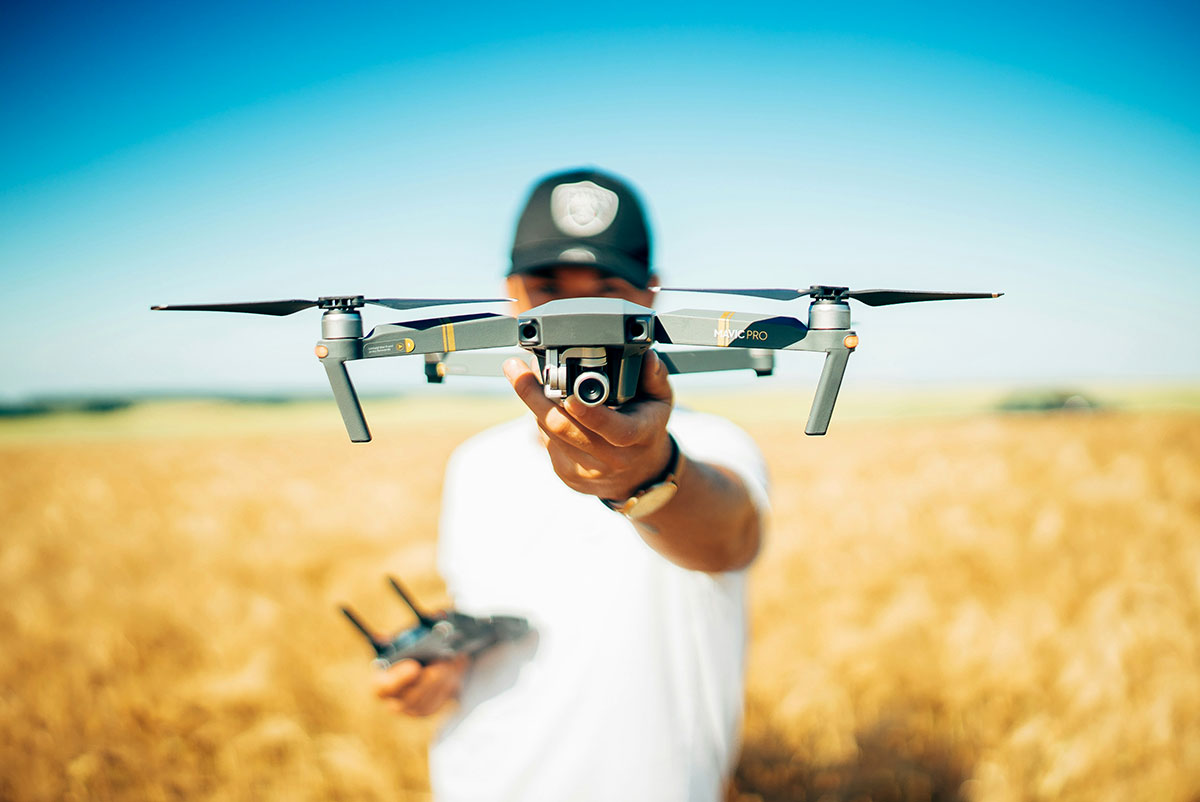 Image of a man holding a video drone for the fullframe blogpost, image by david henrichs on Unsplash.