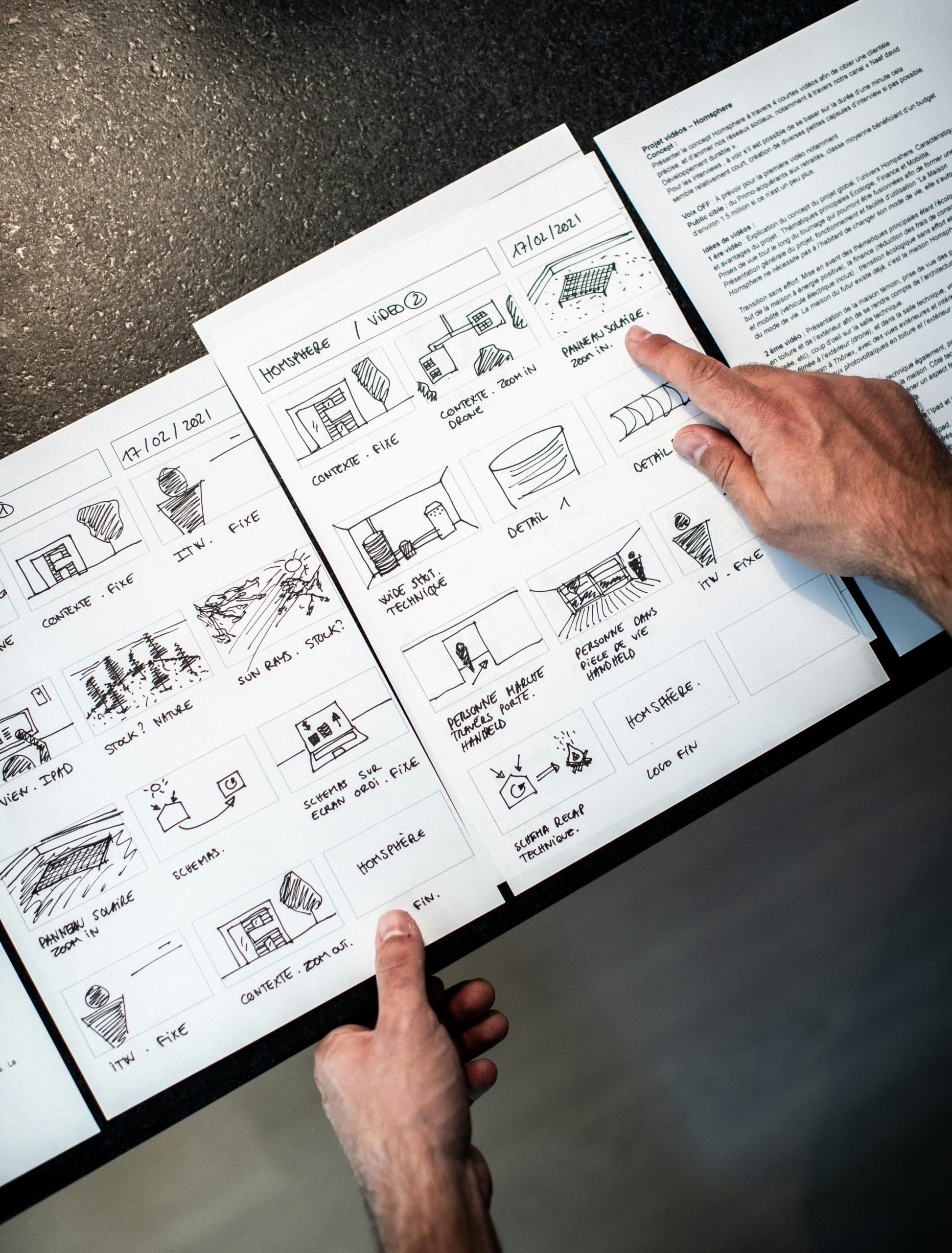 A picture of a man pointing at a storyboard during the process of video production or animation. Photo taken from unsplash