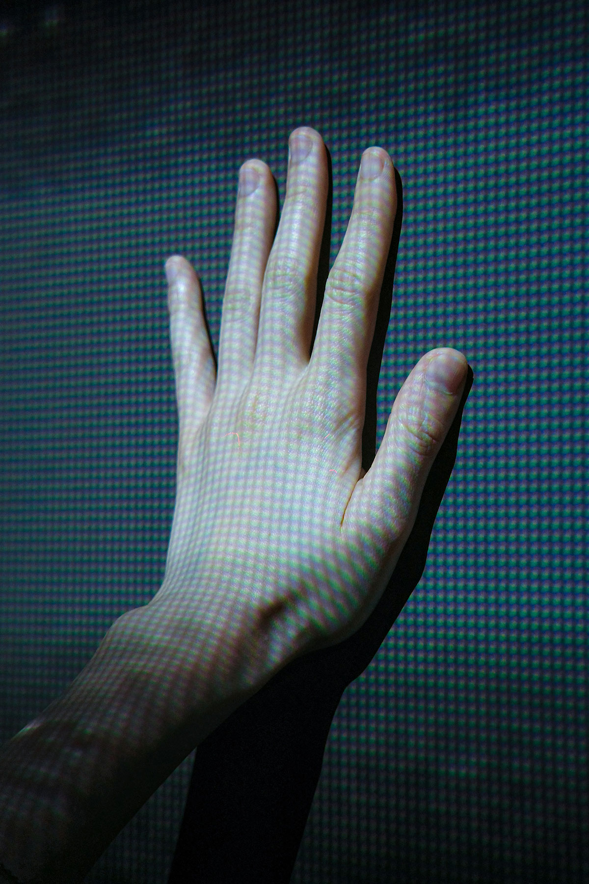 An image of a hand pressed up against a LED screen for the Fullframe blogpost on interactive videos, image by dynamic wang on unsplash.