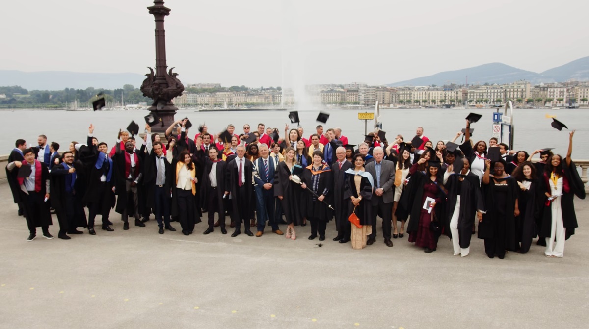 Image of a graduation class in Geneva, Switzerland throwing up their hats as event photography sample by the Fullframe Creative Agency.