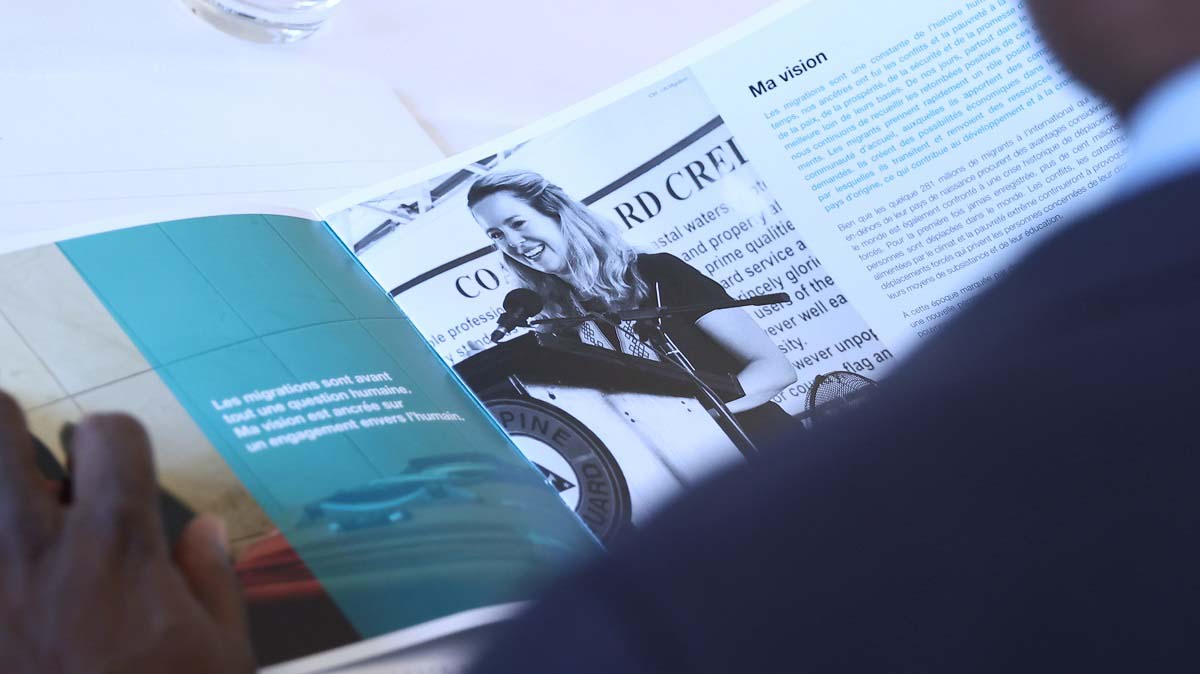 Image of a man reading a brochure created by the fullframe agency for a social media marketing campaign for Amy Pope of IOM.