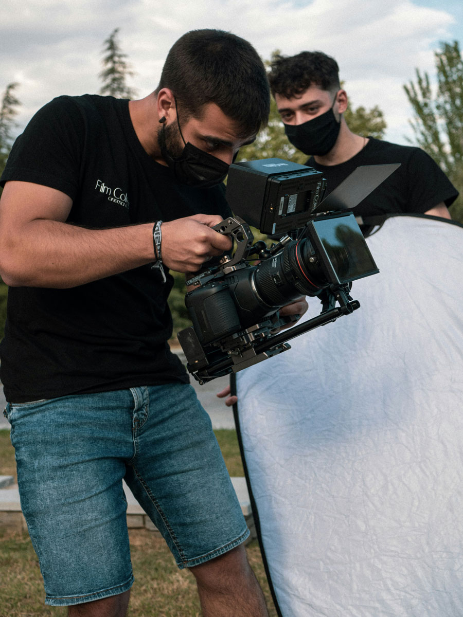 An image of two video production workers holding a camera and reflector for the fullframe blog post on artificial intelligence, image by jose p ortiz on unsplash