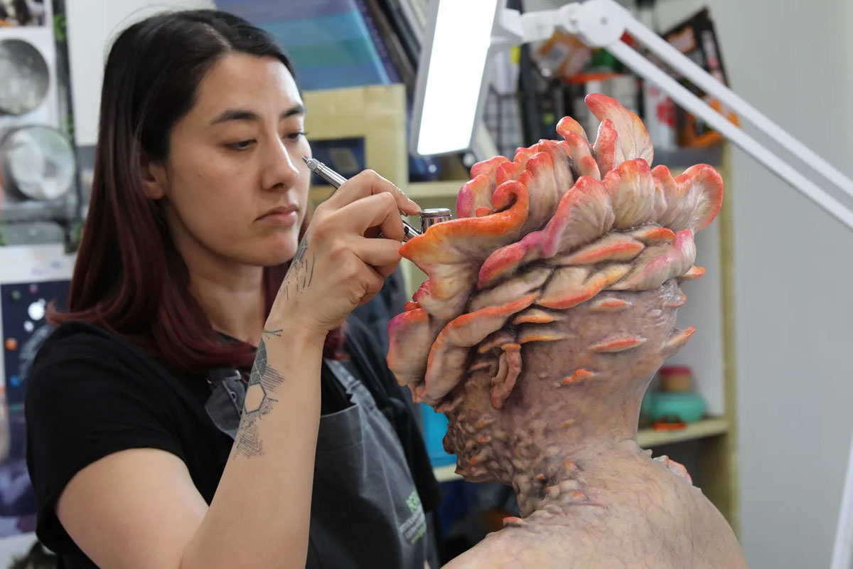 A behind the scenes image of artist vfx makeup on set of The Last of Us, image from Allure , for the fullframe blog on practical effects in 2024