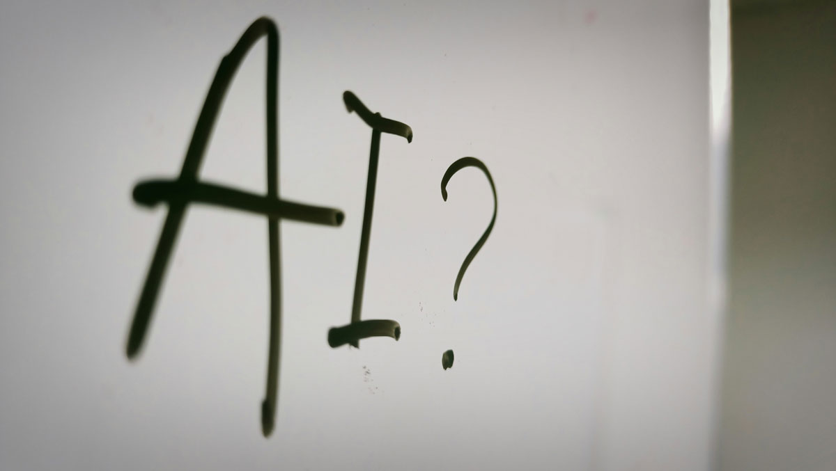 An image of the letters a and i and a question mark written on a white board for the fullframe blogpost on artificial intelligence in video production, image by kadri nahrizul on unsplash