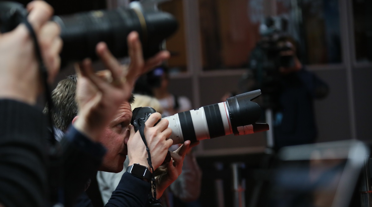 Image of a press photographer at a press conference covered by the Fullframe Creative Agency in Geneva.