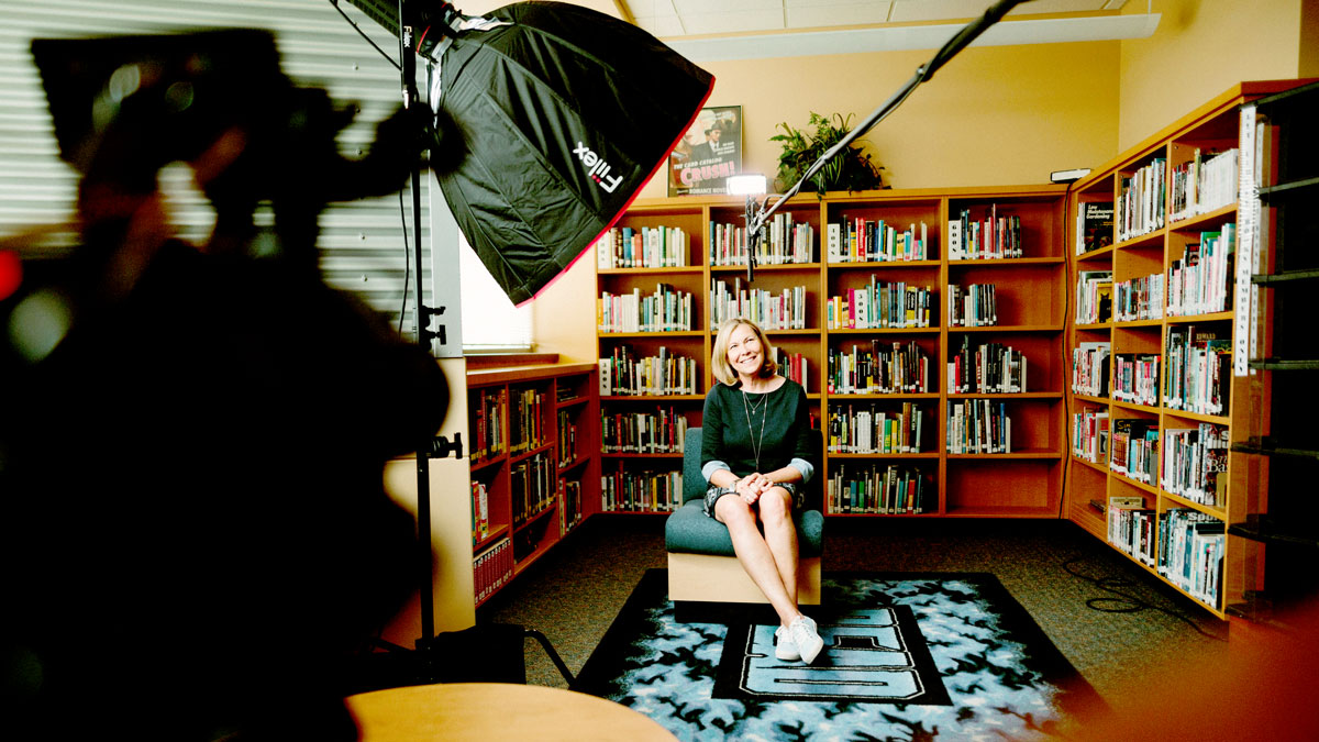 An image of a woman being interviewed in a library for the fullframe blog on interview video production, image by sam mcghee on unsplash