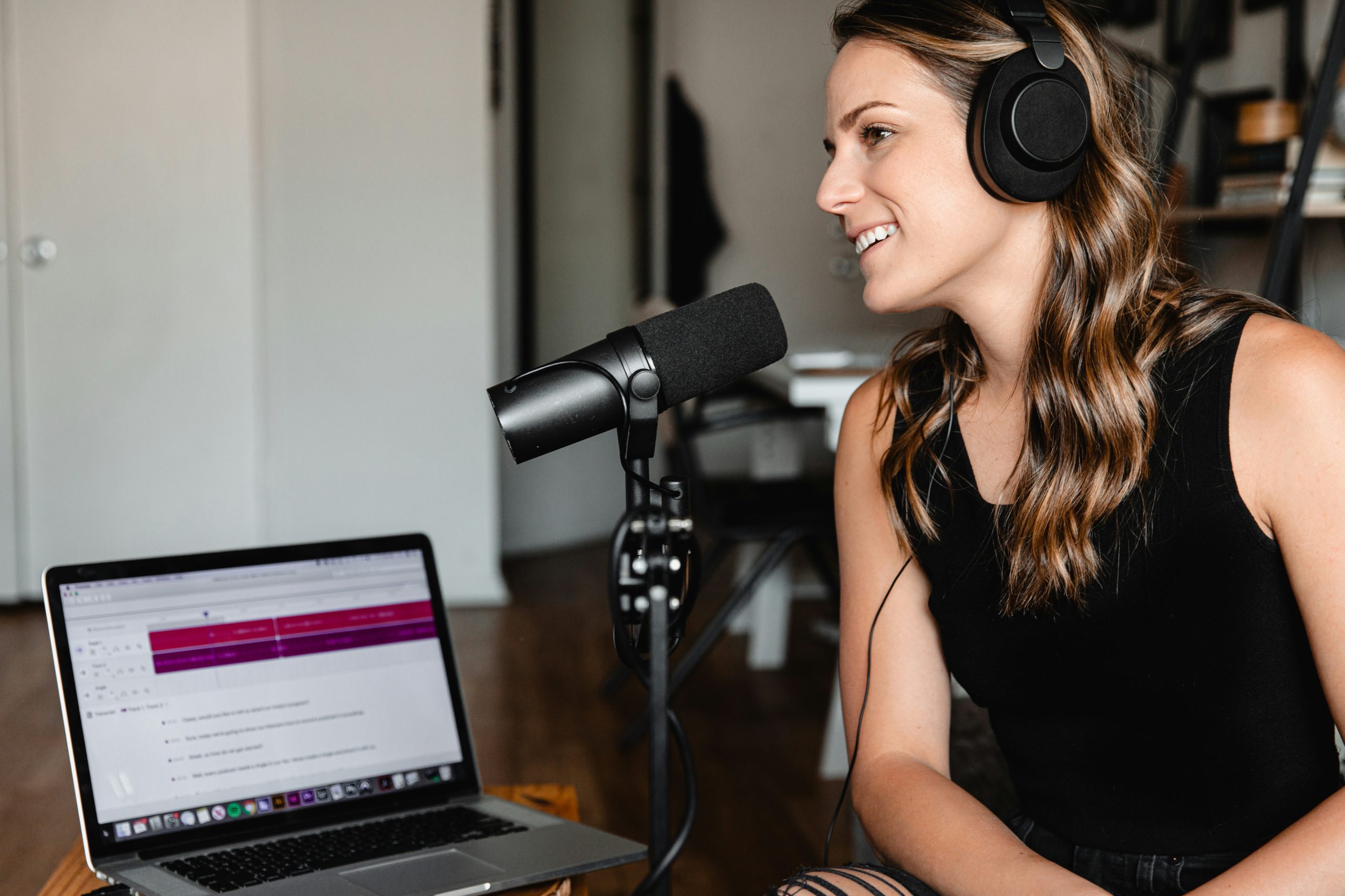 A woman voice recording for a podcast for the fullframe blog on voice acting in video production, image by soundtrap on unsplash