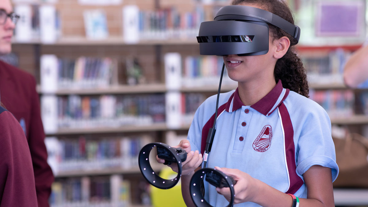 A girl using a virtual reality vr headset and remotes for the Fullframe blogpost on ar augmented reality, vr virtual reality, mr mixed reality, xr extended reality in video production. Image by stem t4l on unsplash