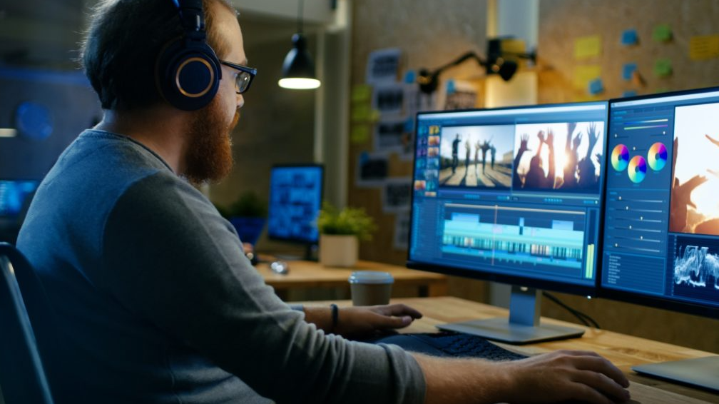 An image of a producer working on a computer with two monitors for the fullframe creative agency video production blogpost on video editing