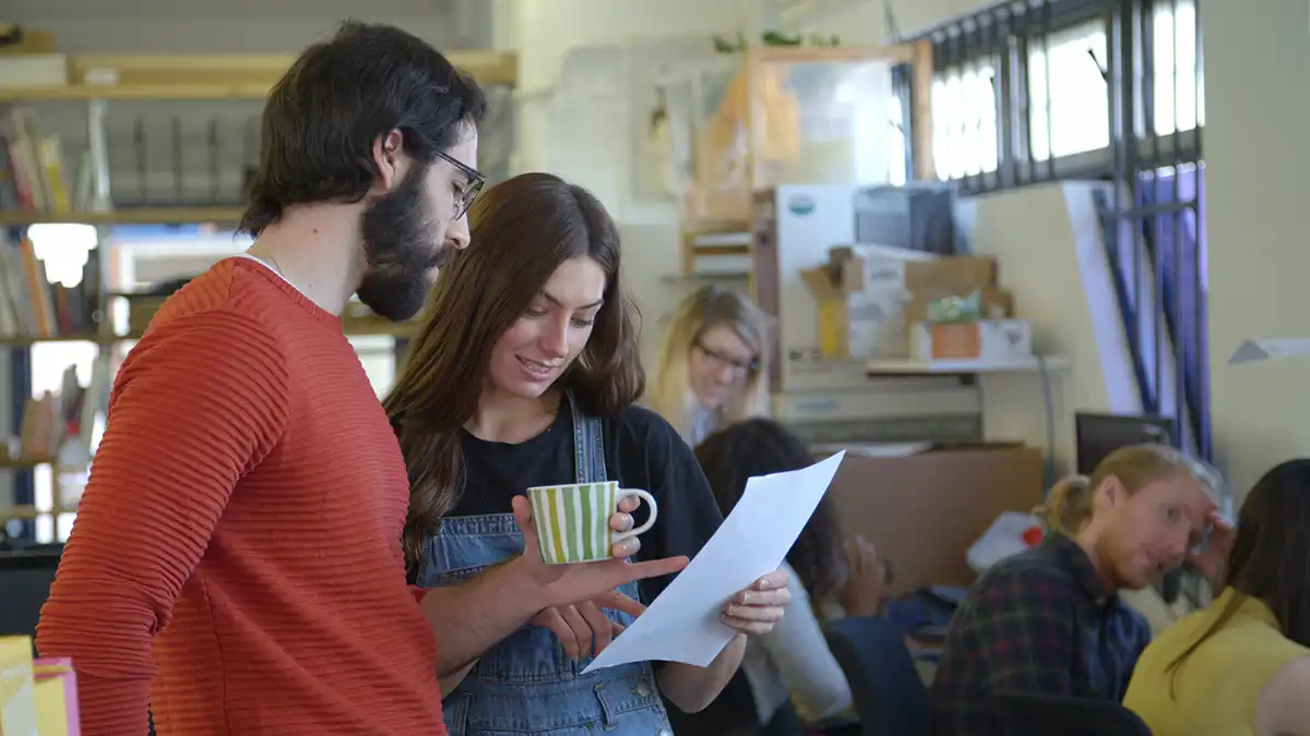 Man and woman discussing a video production project during a preproduction meeting at the fullframe creative agency